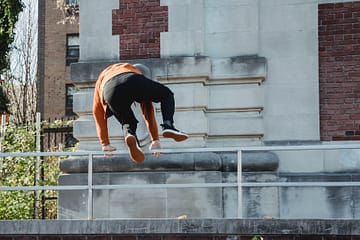 strong man jumping over obstacle during training